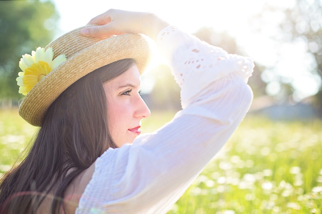 Woman with healthy skin in a sunlit field